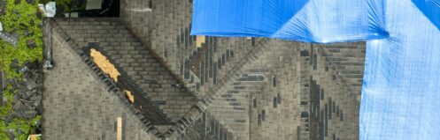 Storm damaged roof with tarp