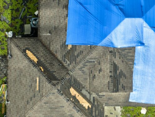 Storm damaged roof with tarp